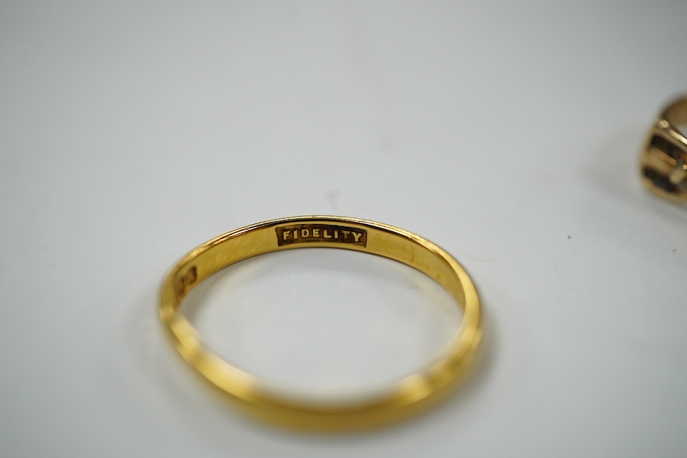 A modern 9ct gold buckle ring, 2.2 grams and a 22ct gold wedding band, 1.6 grams. Condition - poor